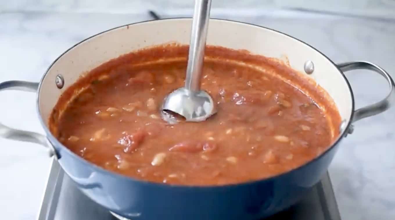 Using an immersion blender to blend tomato soup