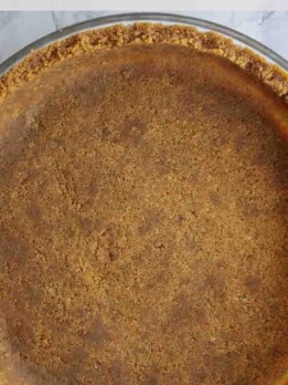 A closeup of a 2-ingredient gingersnap pie crust in a pan dish
