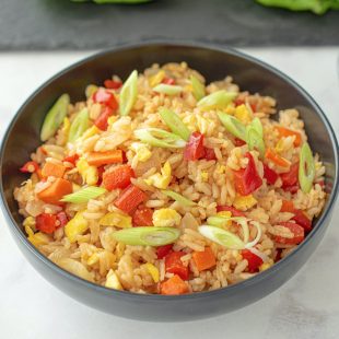 Vegetable fried rice in a black bowl