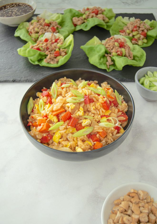 A bowl of vegetable fried rice with chicken lettuce wraps
