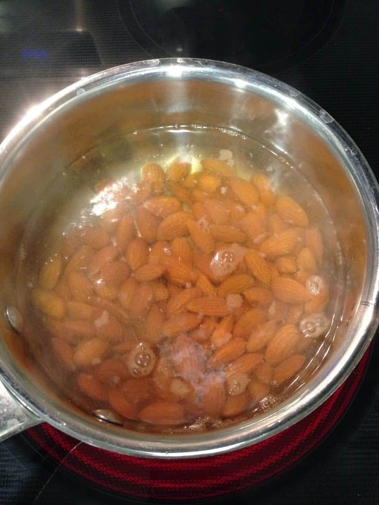 Almonds boiling in a pan of water