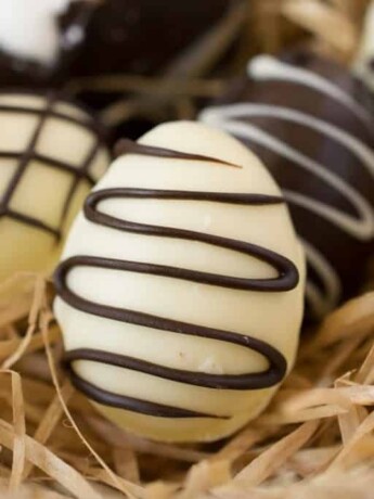 A white chocolate egg drizzled with dark chocolate