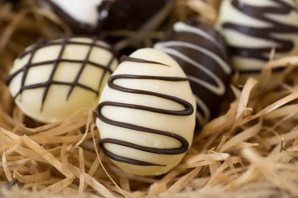A white chocolate egg drizzled with dark chocolate