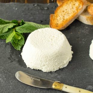 Ricotta with a knife, fresh mint and bread