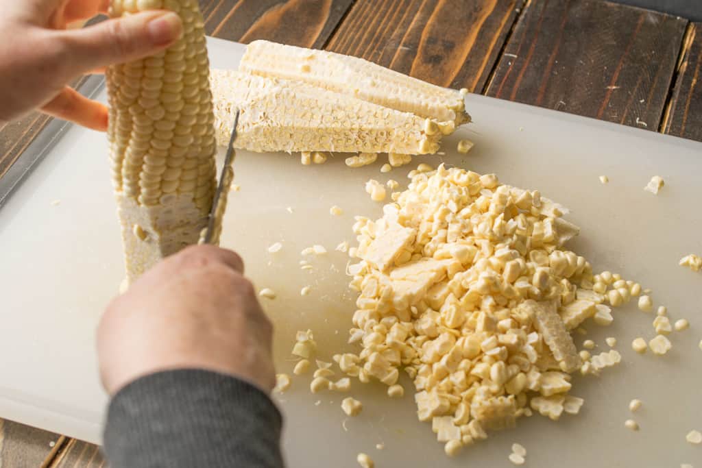 Cutting corn kernels from the cob