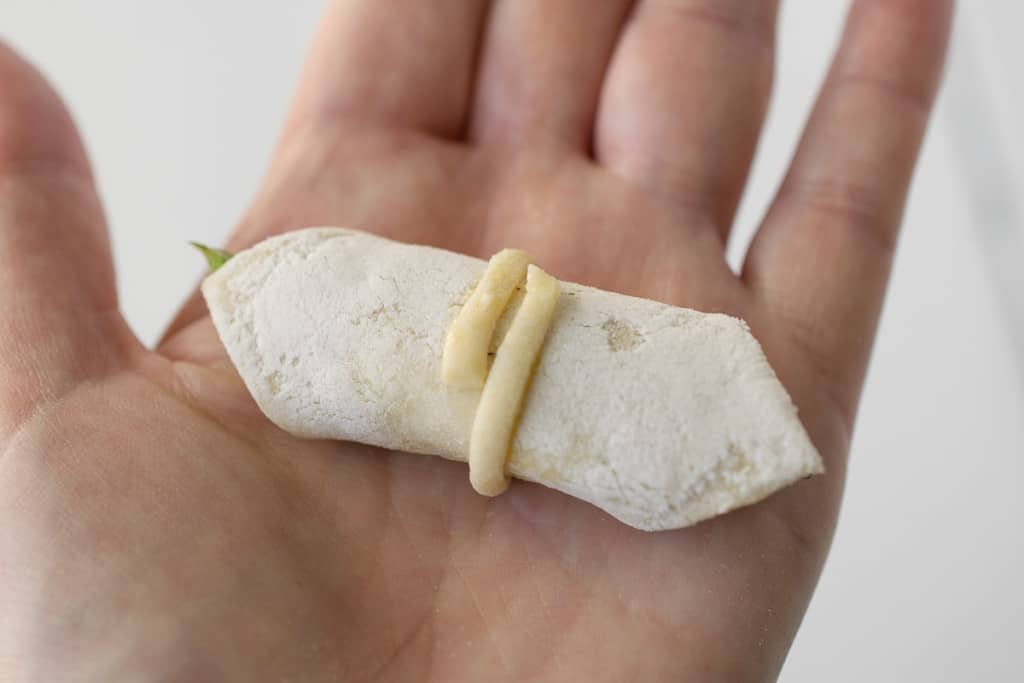 A roll of puff pastry bite in a hand