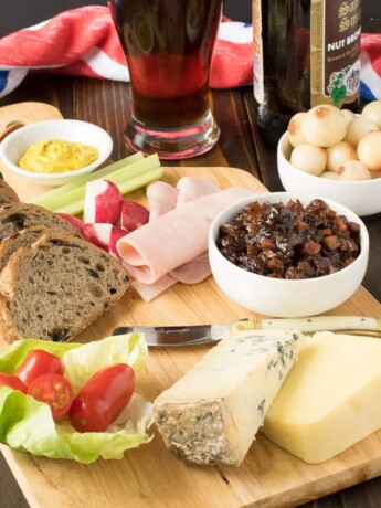 A very British and extremely popular pub lunch item, the Ploughman's lunch is a meal consisting of cold meats, cheese, bread, pickle and of course, beer. It's like a picnic on plate. This recipe, the fabled Ploughman's lunch, completes my British recipes week.