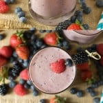 Glasses of berry smoothie with whole pieces of fruit
