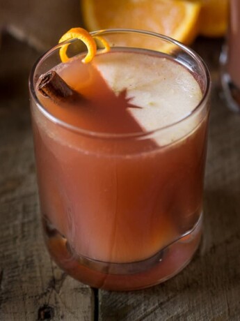 A glass of sparkling apple punch with a floating slice of apple