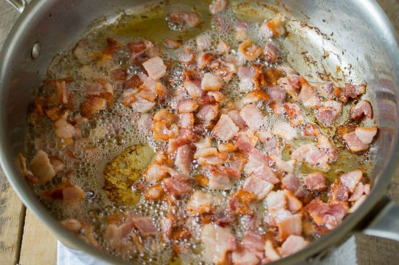 The bacon crisping in a pan