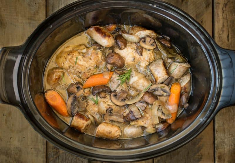 Looking from overhead showing chicken, sausage and vegetables in the slow cooker