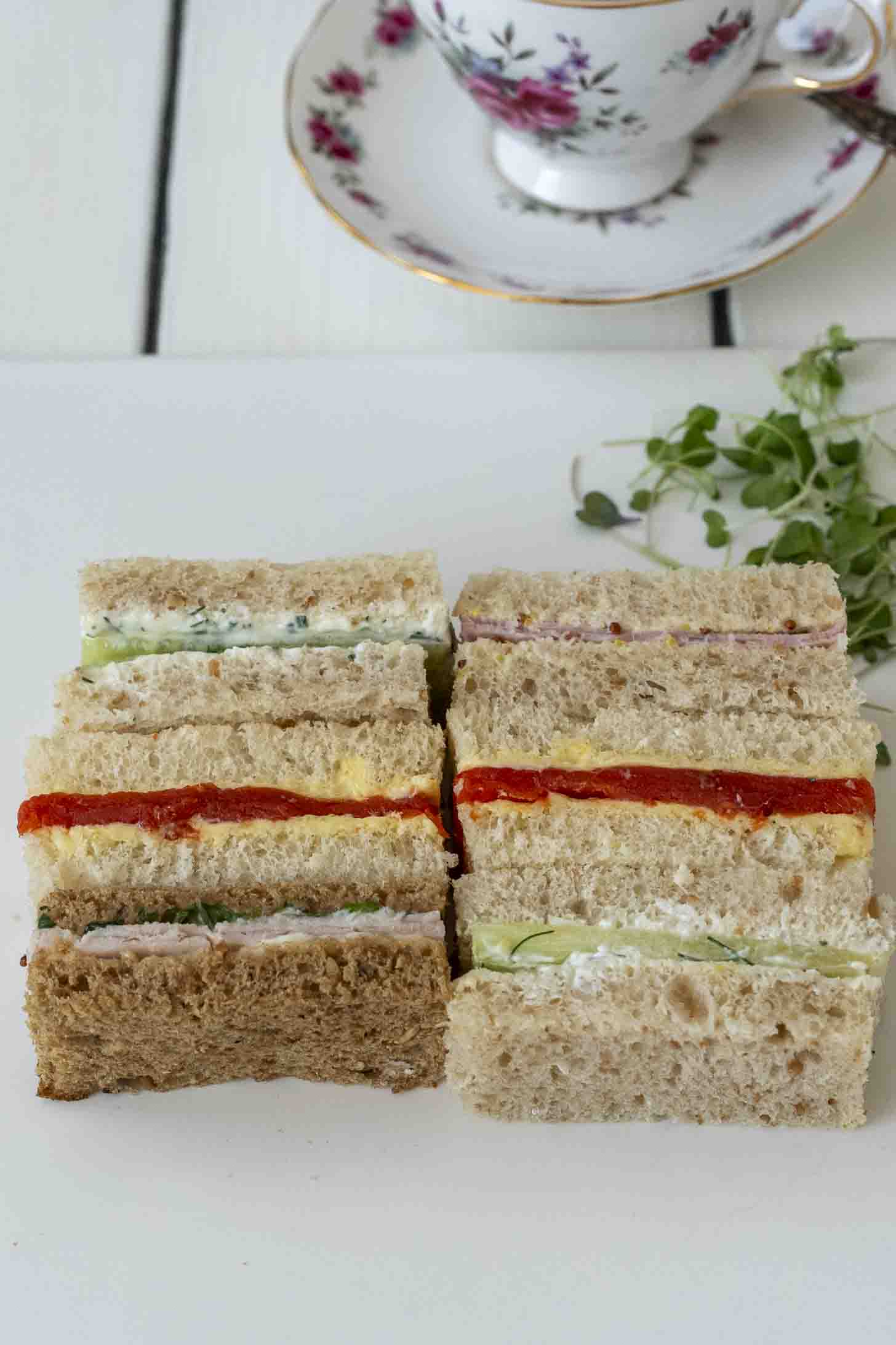 6 finger sandwiches on a white plate