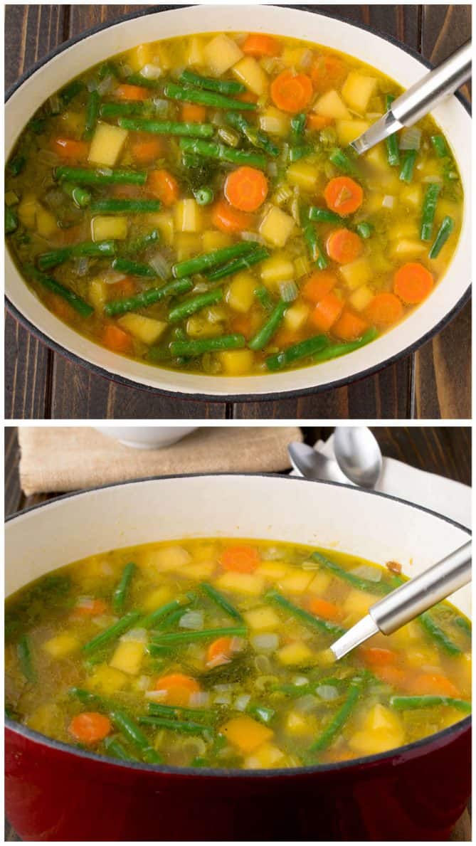 An oval dutch oven filled with colorful vegetable soup with carrots, butternut squash, green beans