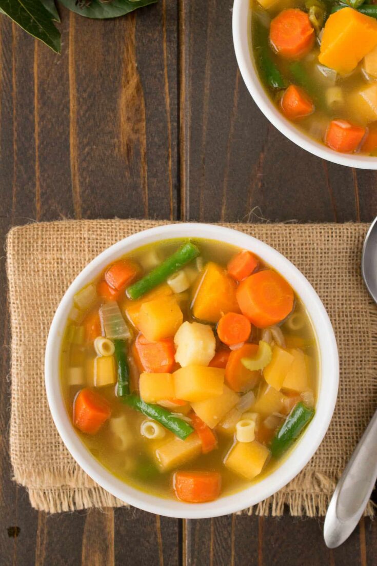 30 minute winter vegetable soup viewed from overhead in a white bowl with a spoon