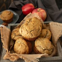 Apple pie pecan muffins in a burlap lined wood bowl