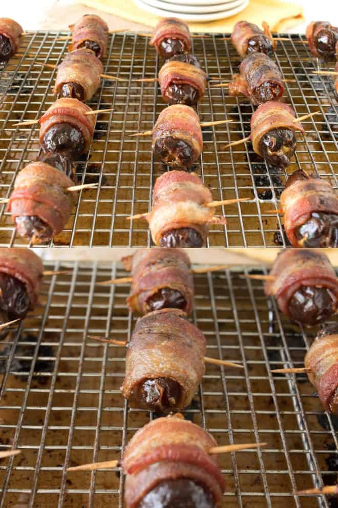 Apple stuffed bacon wrapped dates on a baking rack right out of the oven