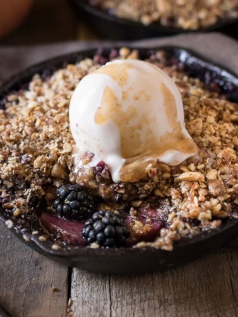 Apple and blackberry crumble topped with vanilla ice cream