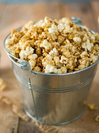 A silver bucket of of apple cider caramel popcorn