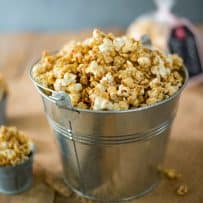 A silver bucket filled with Apple Cider Caramel Popcorn