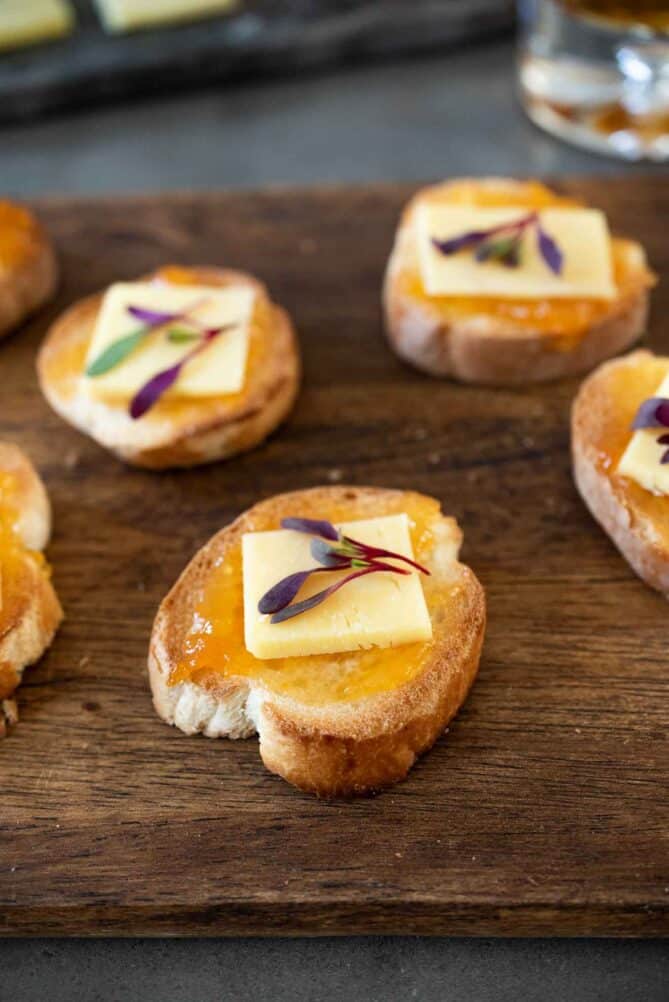 Apricot and cheddar crostini on a serving board