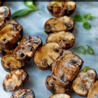 A closeup of grilled mushroom skewers covered with a delicious sauce