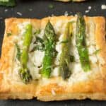 A closeup of a small asparagus tart