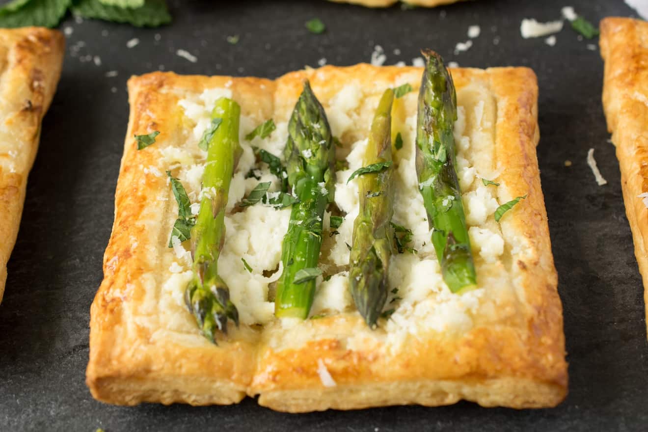 A closeup of a small asparagus tart