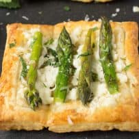 A square puff pastry tartlet topped with ricotta, mint and asparagus