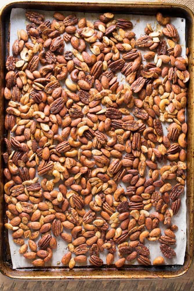 A baking sheet spread with mixed nuts