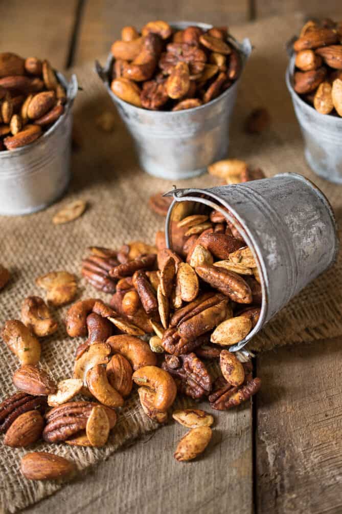 Mixed, spiced nuts spilling out of a mini bucket