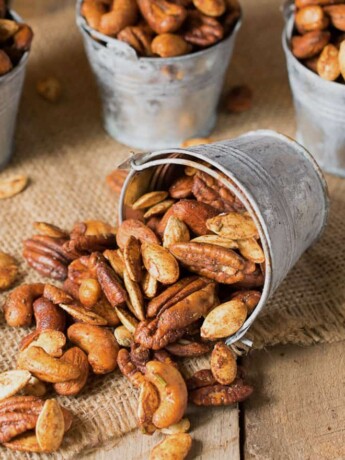 Almonds, pecans, cashews and pumpkin seeds spilled out onto a mat