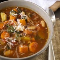 A closeup showing the carrots, squash and beans in the soup