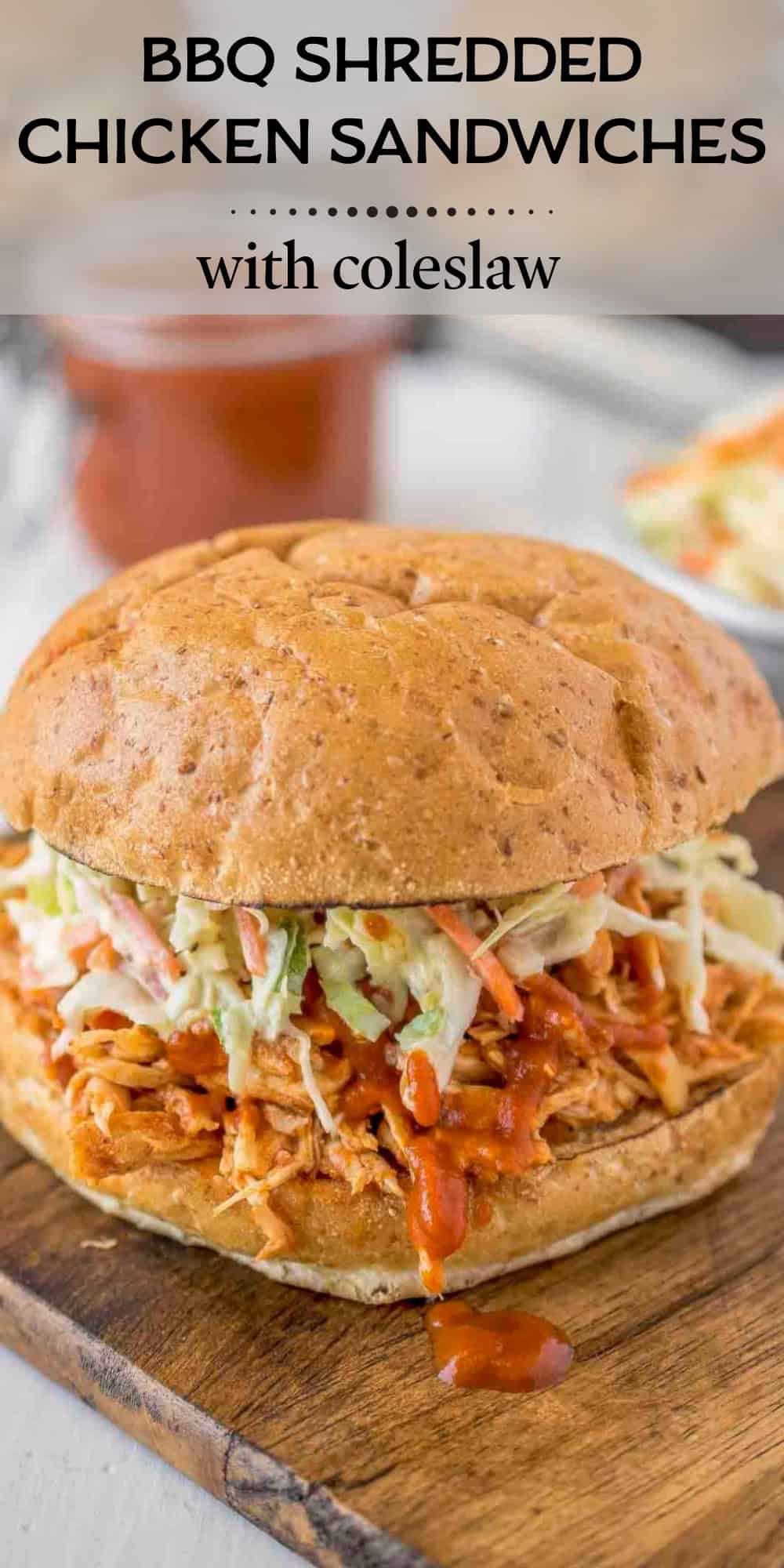 Close-up side view of a homemade BBQ shredded chicken sandwich with fresh coleslaw