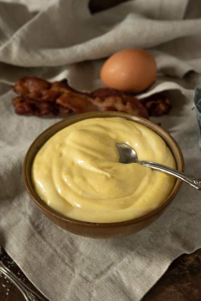 A bowl of mayonnaise with a spoon