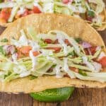 A corn tortilla filled with halibut, pico de gallo, cabbage and Mexican cream