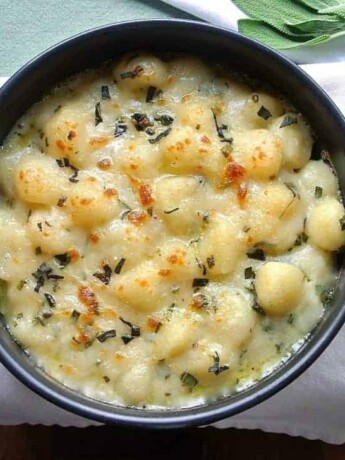 Bubbly with a brown top, cheese sauce with fresh sage and gnocchi