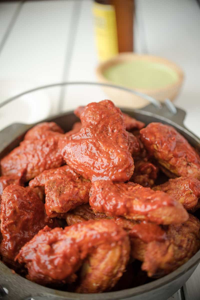 A closeup of wings soaked in adobo sauce