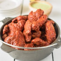 Baked adobo chicken wings bring a Mexican twist to a favorite finger food. Wings are baked to crispy perfection then bathed in a delicious adobo sauce made with dried peppers and spices. Grab the napkins...