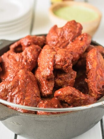 Baked adobo chicken wings bring a Mexican twist to a favorite finger food. Wings are baked to crispy perfection then bathed in a delicious adobo sauce made with dried peppers and spices. Grab the napkins...
