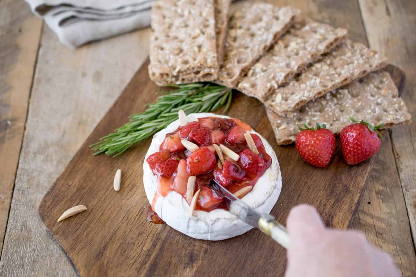 Cut brie garnished with strawberries