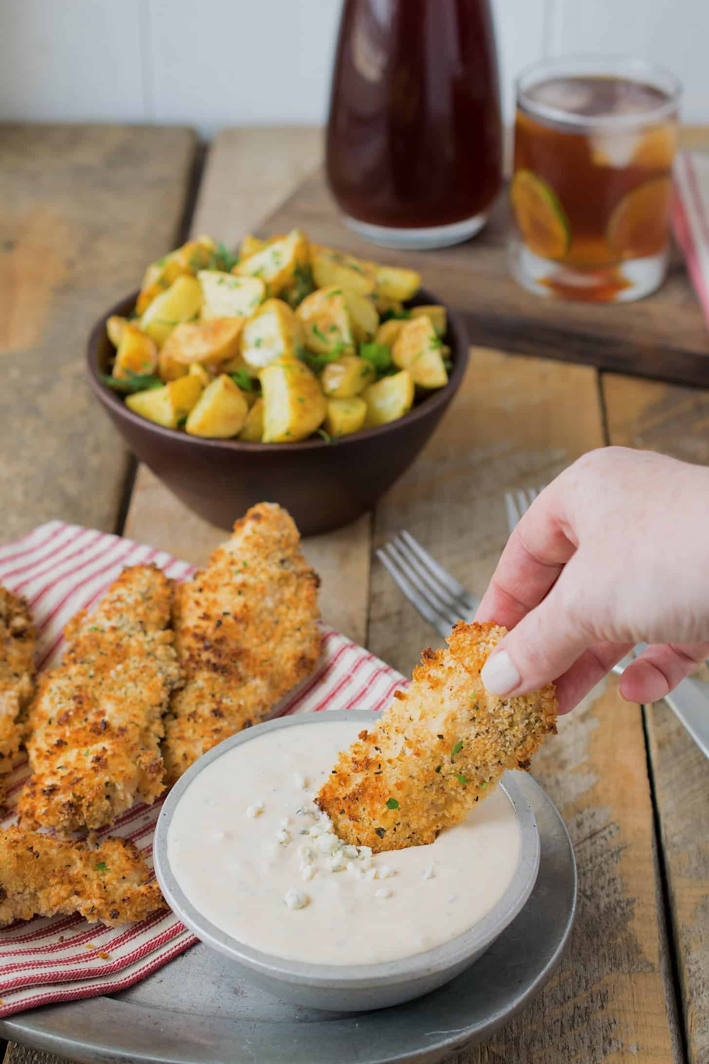 Dip tender, breaded chicken in blue cheese sauce