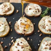 Drizzling honey over baked pears with goat cheese and pecans