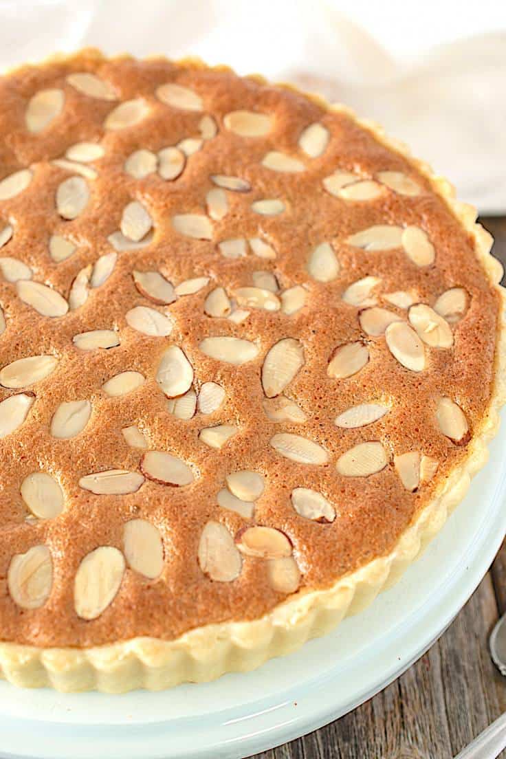 A closeup of a classic bakewell tart showing the sliced almond in the topping