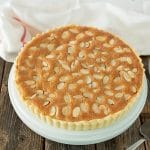 A classic bakewell tart with flaky pastry layered with jam and almond sponge topped with sliced almonds