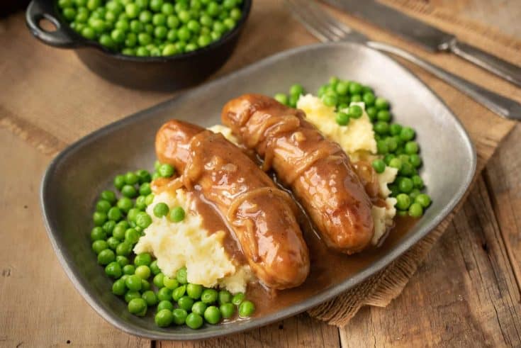 2 British bangers on a bed of mash with peas