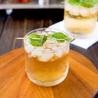 A glass of basil julep on a board