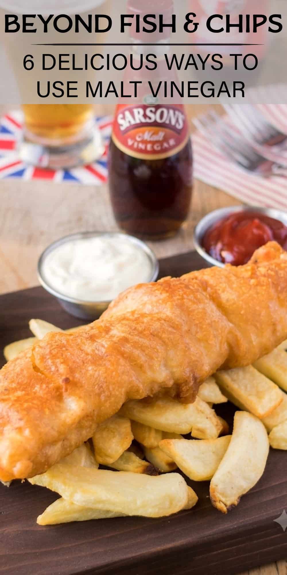 Fish and chips on a board with malt vinegar