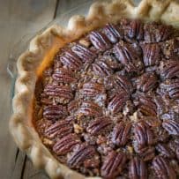 A closeup of Bourbon Pecan Pie showing the browned crust and pecan topping