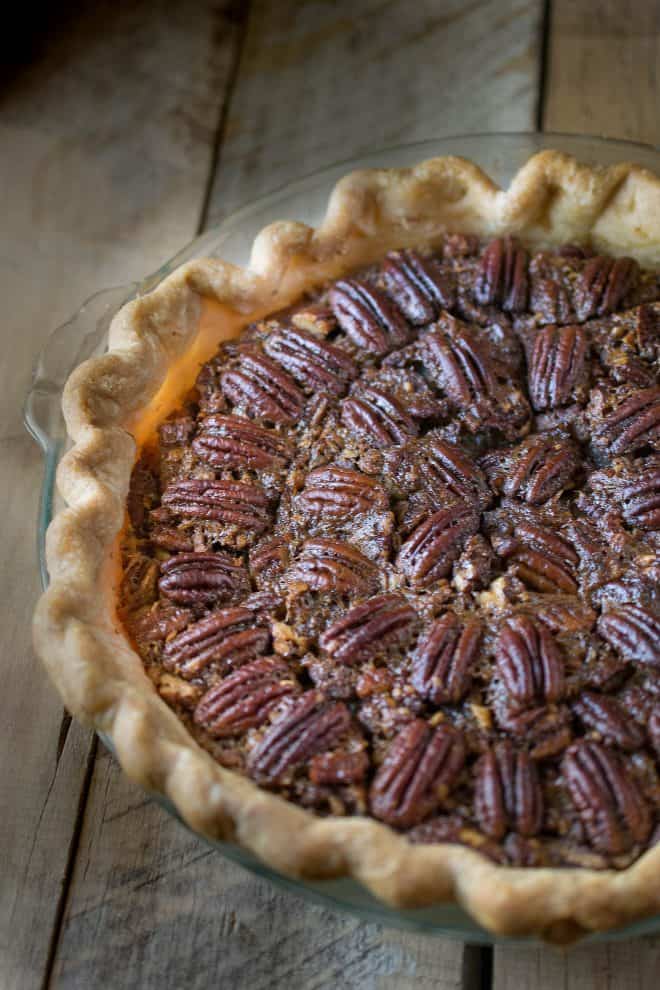 A closeup of Bourbon Pecan Pie showing the browned crust and pecan topping