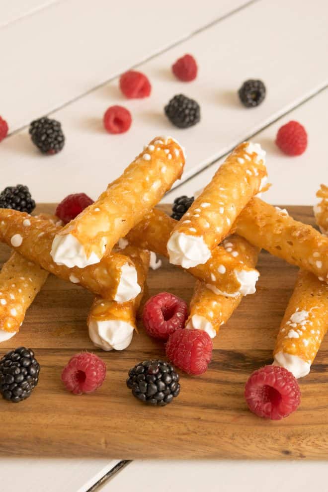 Brandy Snaps stacked on one another with berries